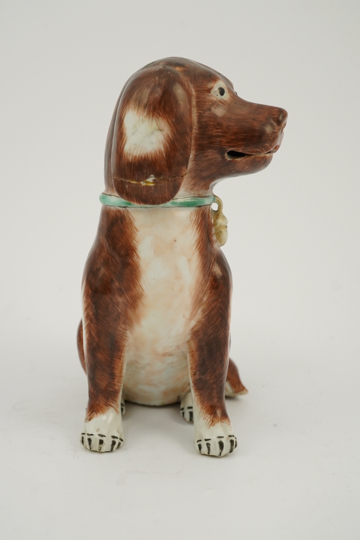 A Chinese export enamelled porcelain model of a seated spaniel, Qianlong period